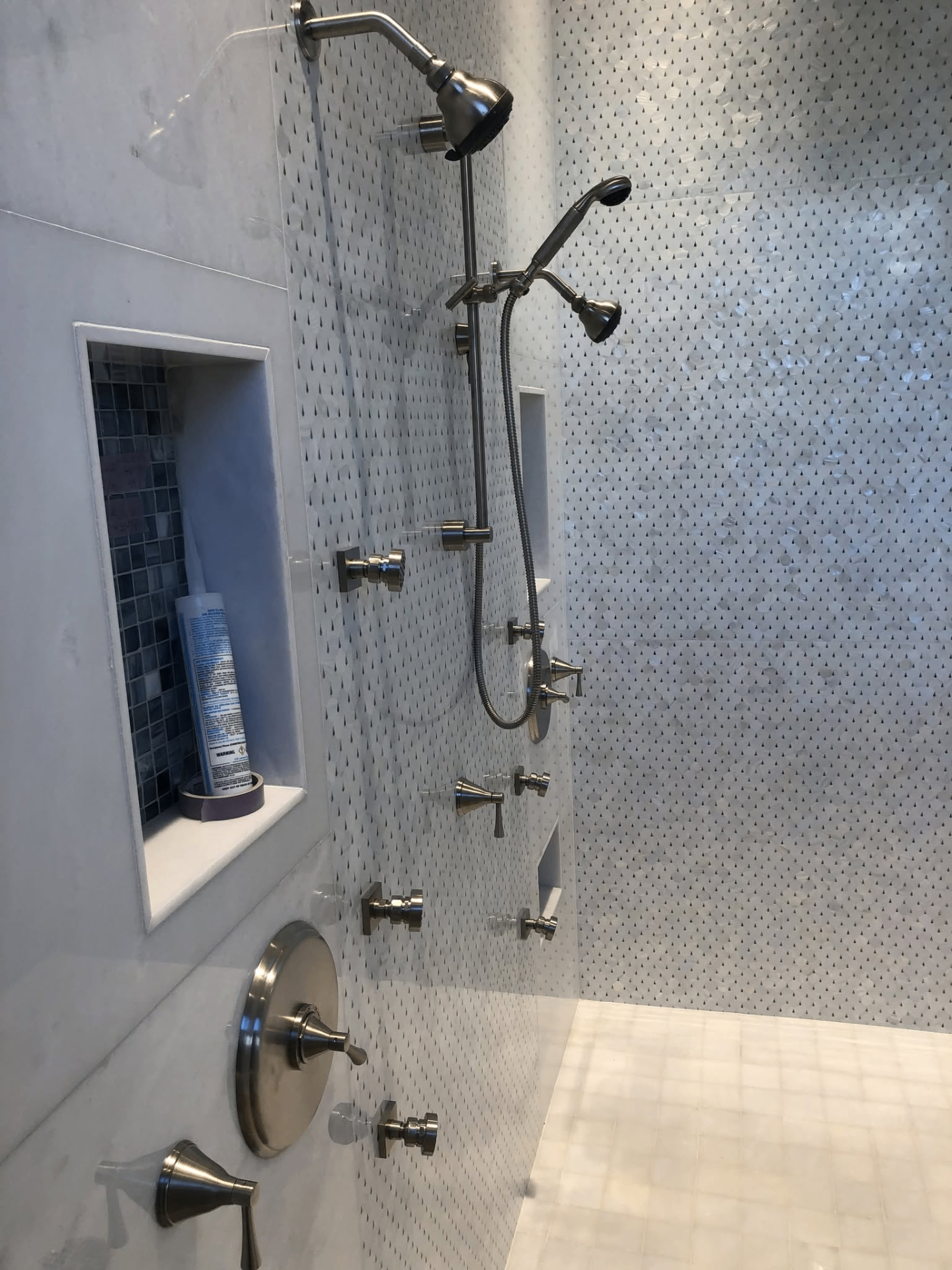 Marble shower with custom niche and body sprays