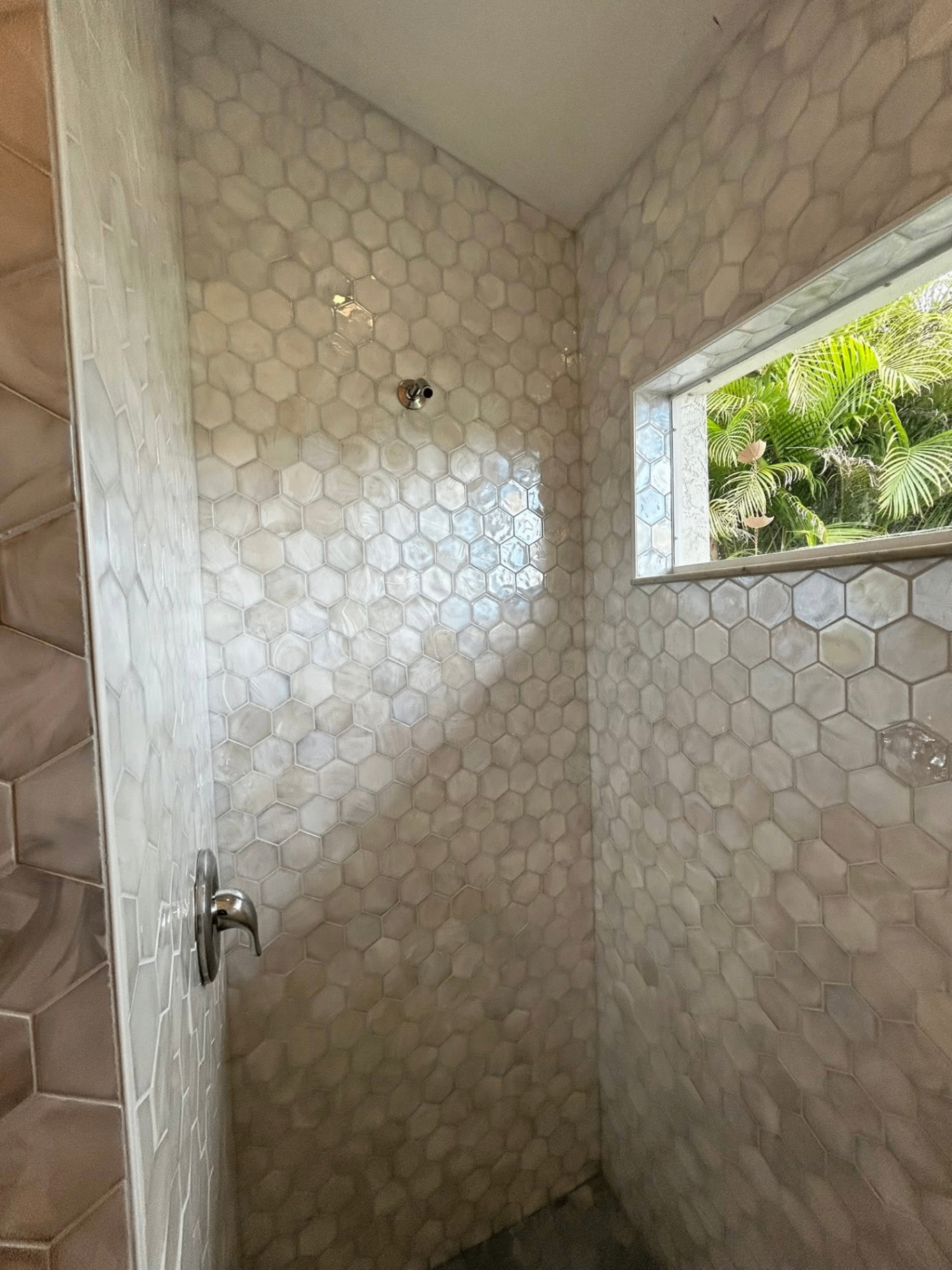 Hexagon mother-of-pearl shower tile installation